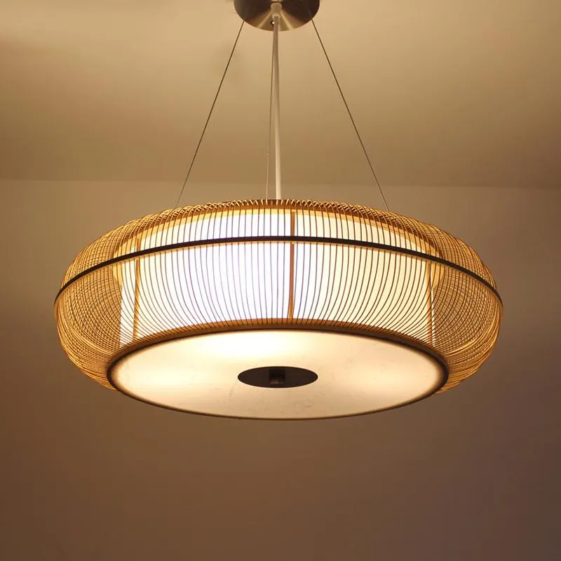 Caged circular pendant light in black or beige