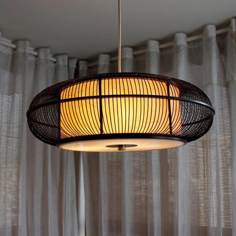 Caged circular pendant light in black or beige