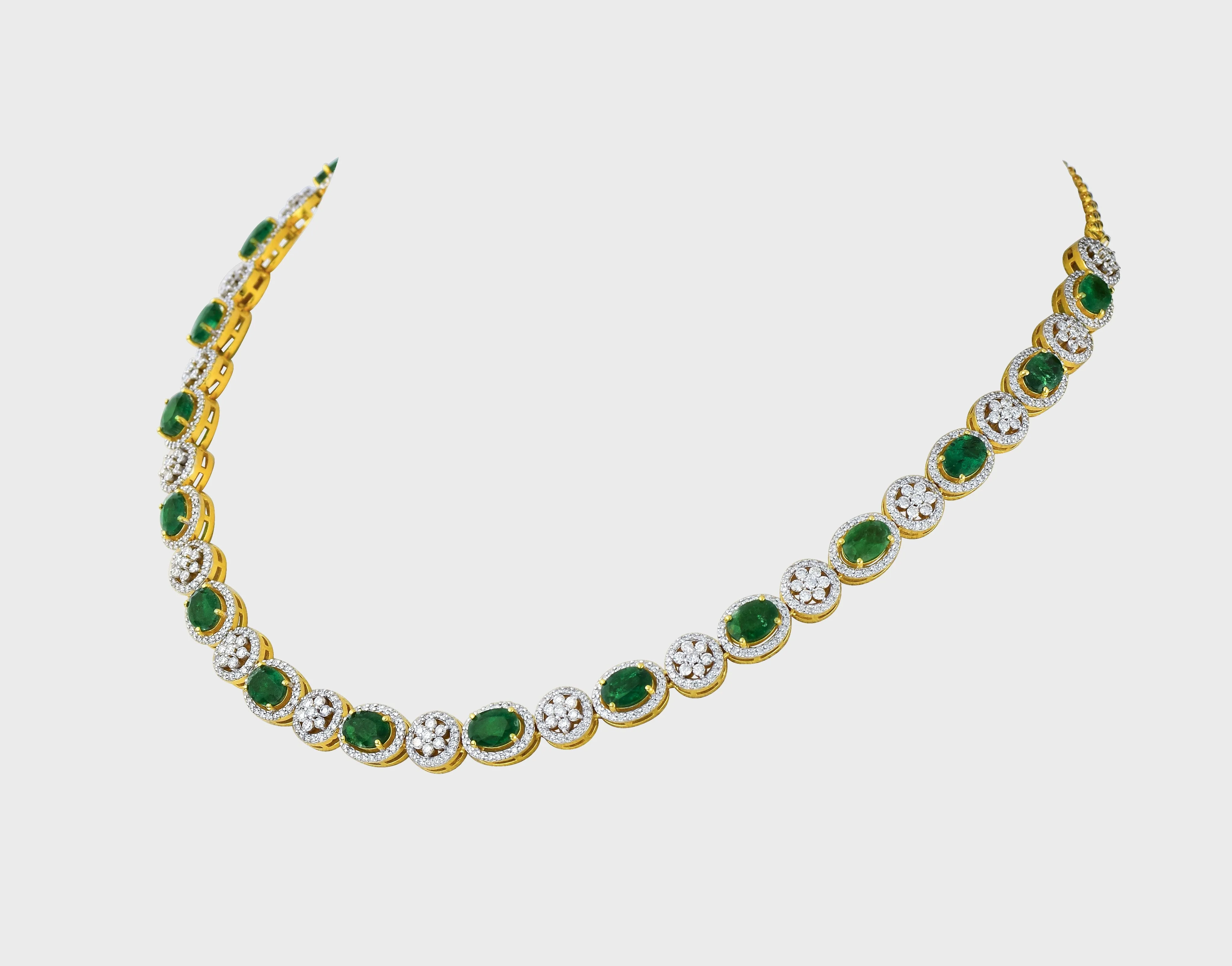 Enchant with elegance in our Emerald oval and diamond necklace and earring pair. Each piece exudes timeless sophistication and luxury.(GDNE0470)