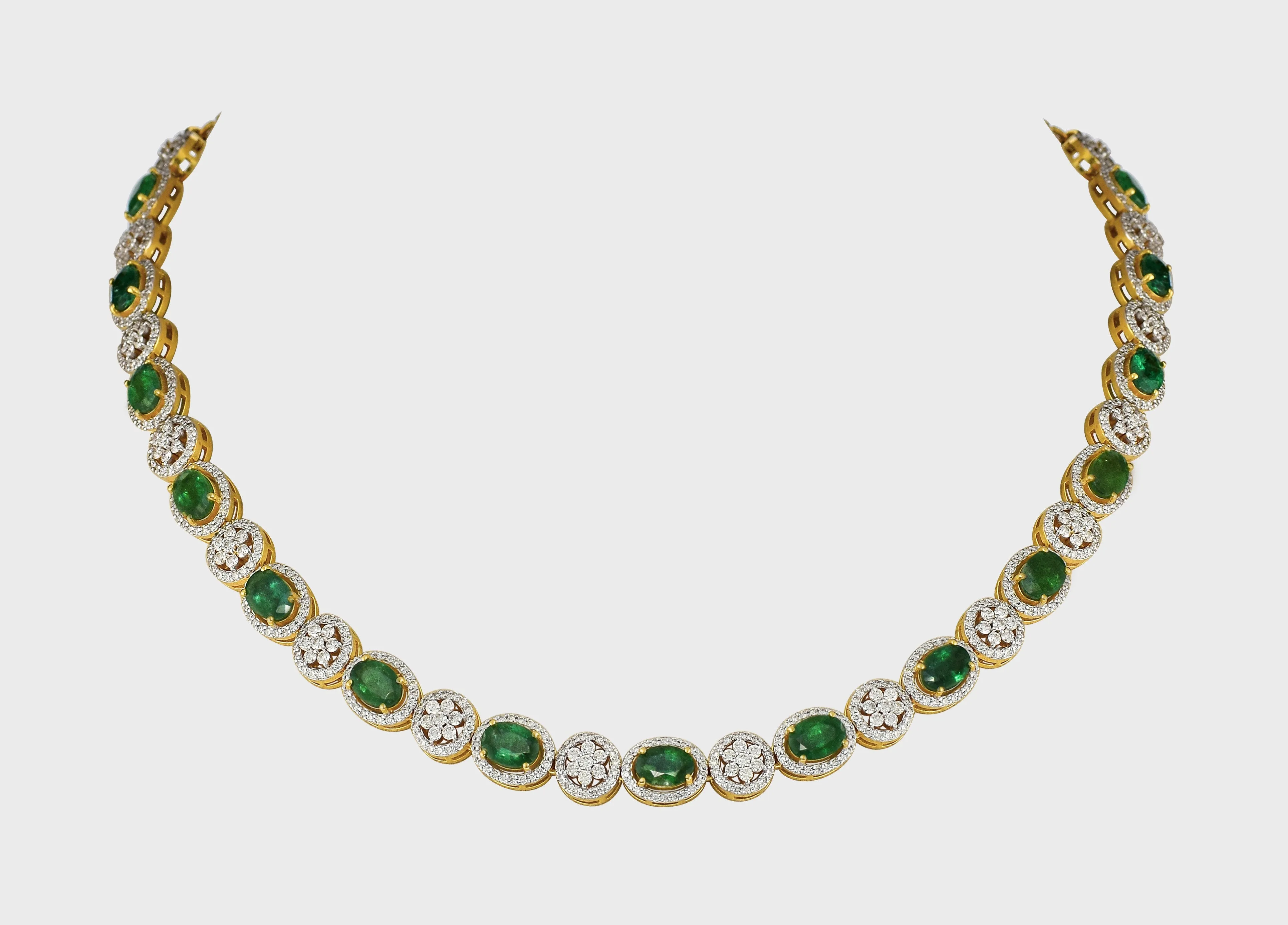 Enchant with elegance in our Emerald oval and diamond necklace and earring pair. Each piece exudes timeless sophistication and luxury.(GDNE0470)