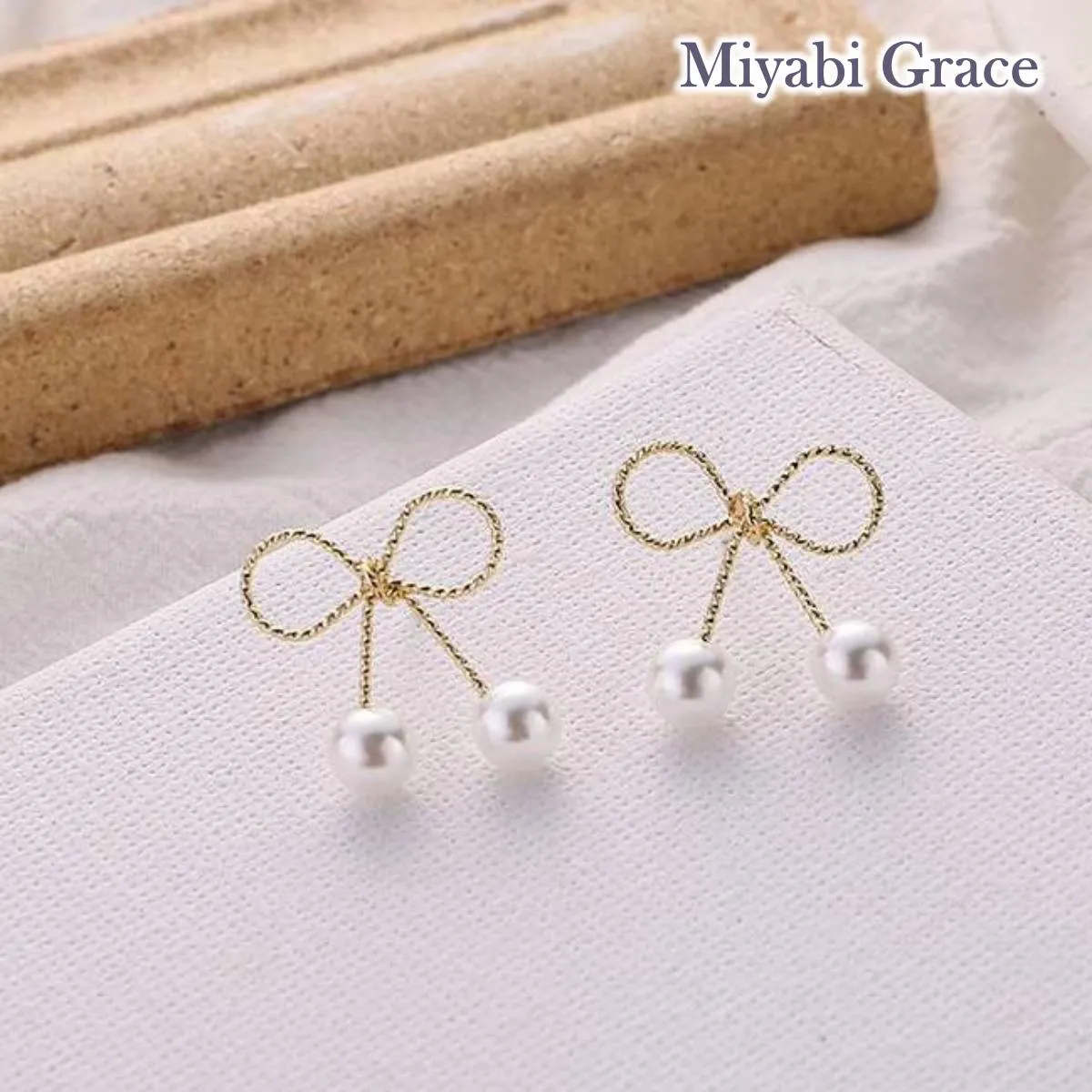 Gold Ribbon White Pearl Tie Invisible Clip On Stud Earrings