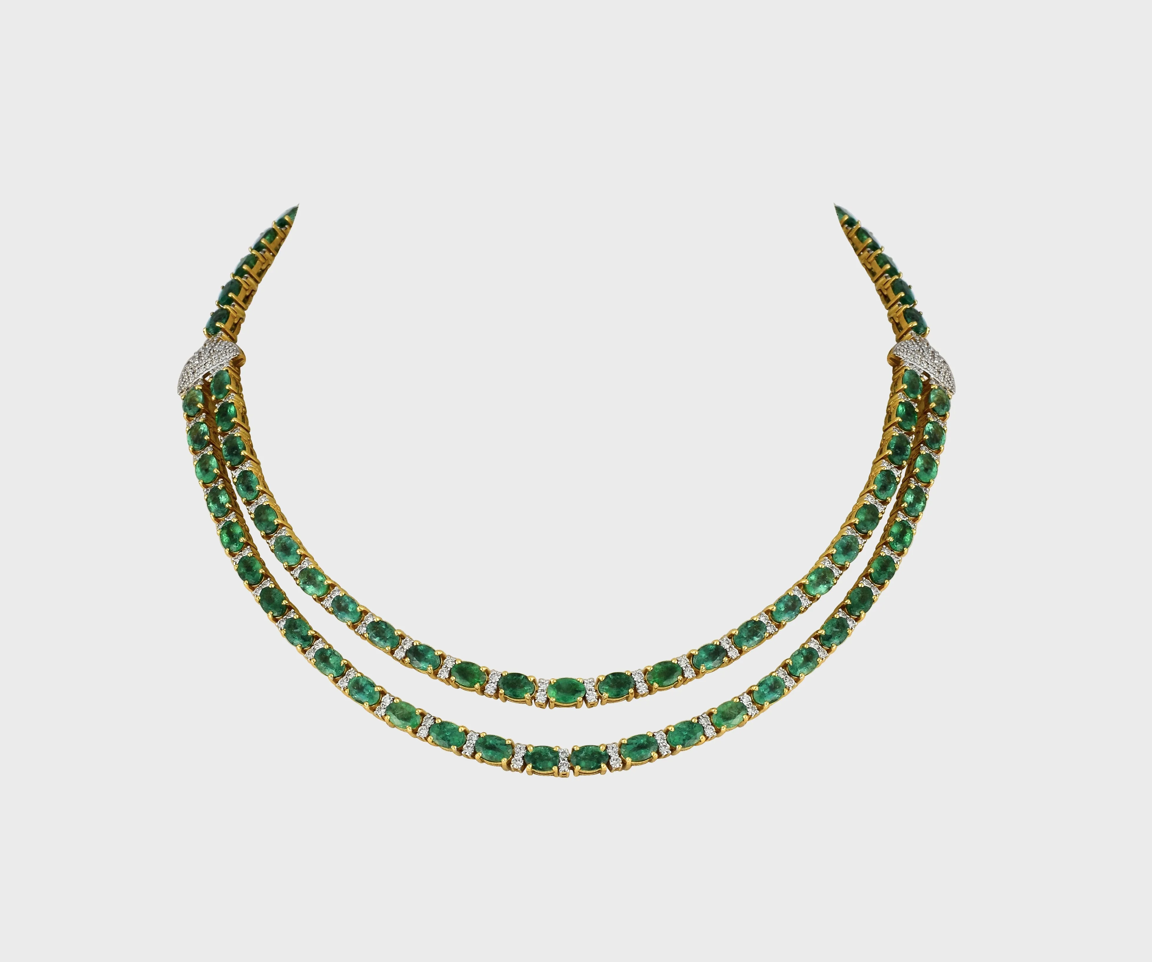 Our double line necklace set features mesmerizing Emerald ovals and dazzling round diamonds, perfectly curated to captivate hearts.(GDNE0488)