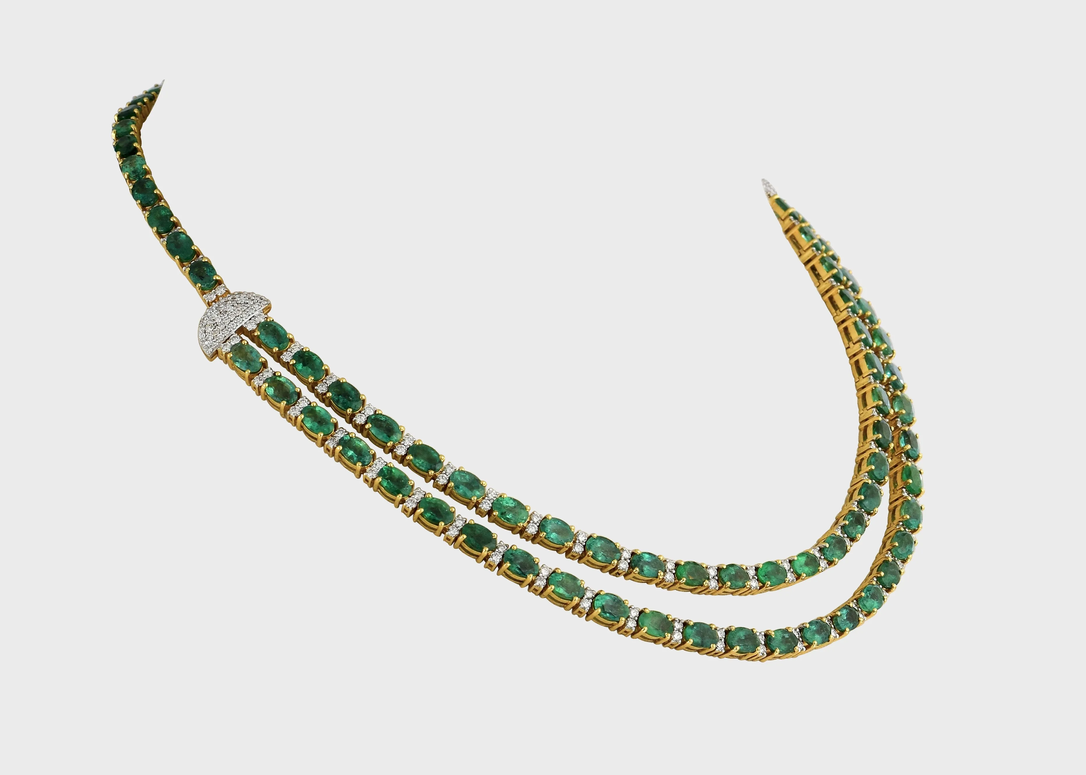 Our double line necklace set features mesmerizing Emerald ovals and dazzling round diamonds, perfectly curated to captivate hearts.(GDNE0488)