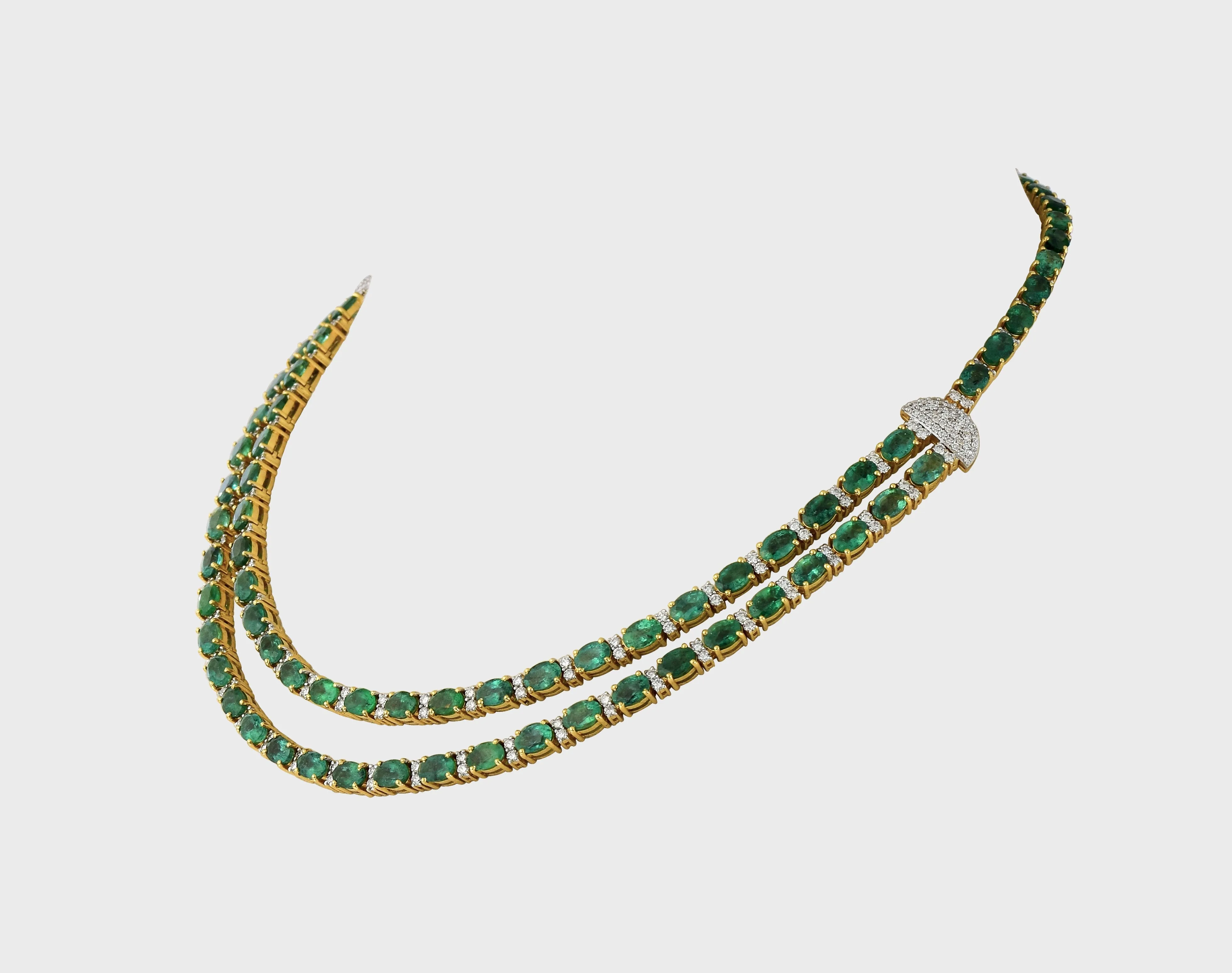 Our double line necklace set features mesmerizing Emerald ovals and dazzling round diamonds, perfectly curated to captivate hearts.(GDNE0488)